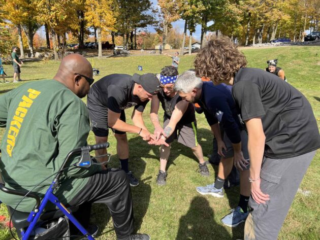 Five Impel team members playing a game.