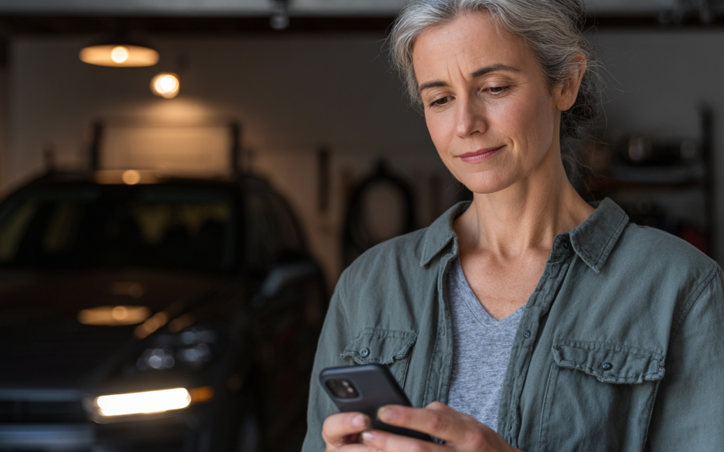 Woman looks at smartphone